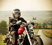 picture of transportation  - Biker on the country road against the sky - JPG 