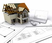 foto of construction  - House under construction on plans with laptop - JPG 