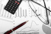 foto of finance  - business finance charts with pen glasses and calculator - JPG 