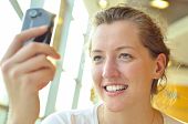 picture of young adult  - a young woman is watching at phone - JPG 