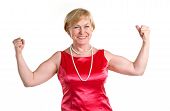 foto of woman  - Portrait of fit senior woman flexing her biceps against white background - JPG 