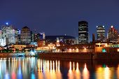 picture of buildings  - Montreal over river at dusk with city lights and urban buildings - JPG 