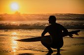 image of sunset  - A surfer watching the waves at sunset in Portugal - JPG 