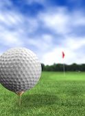 stock photo of golf  - golf ball close up in a course with green grass and a blue sky - JPG 