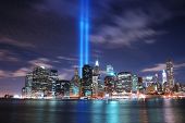 foto of buildings  - New York City Manhattan panorama view at night with office building skyscrapers skyline illuminated over Hudson River - JPG 