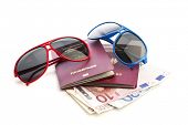 stock photo of currency  - Two sunglasses upon german passports and Euro currency - JPG 