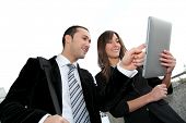 stock photo of meeting  - Business people meeting outside with electronic tablet - JPG 