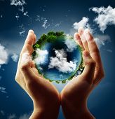 stock photo of earth  - holding a glowing earth globe in his hands - JPG 