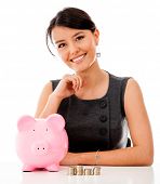 stock photo of money  - Business woman saving money in a piggybank  - JPG 