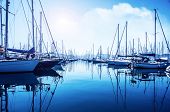 image of transportation  - Picture of row of luxury sailboats reflected in water - JPG 