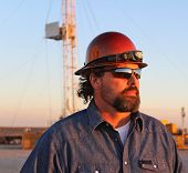 image of nature  - Oil and natural gas field worker watching the sunset - JPG 