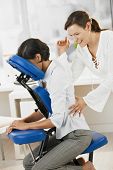 picture of pressure  - Businesswoman sitting on massage chair - JPG 