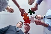 image of puzzle  - Group of business people assembling jigsaw puzzle and represent team support and help concept - JPG 