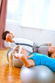 foto of fitness  - Healthy couple making abdominal crunch on fitness ball - JPG 