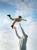 picture of play  - happy father and son playing on sky background - JPG 