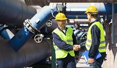 foto of meeting  - Two engineers meeting outside at the piping of an industrial waste water cleaning facility - JPG 