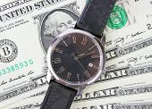 pic of watch  - dollar bills covered with the black watch - JPG 