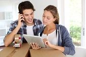 image of transportation  - Couple calling transport company to move in new house - JPG 