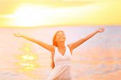 picture of holidays  - Freedom woman happy and free open arms on beach at sunny sunset - JPG 