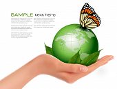 pic of world  - Green world with leaf and butterfly in woman hand - JPG 