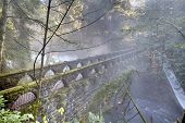 stock photo of bridge  - Whatcom falls and the historic bridge spanning Whatcom Creek in the misty - JPG 