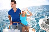 stock photo of outdoor  - Young couple navigating on a yacht in caribbean sea - JPG 