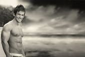 stock photo of outdoor  - Classic outdoor portrait of a great looking shirtless muscular male model against dramatic skyscape in monochrome - JPG 