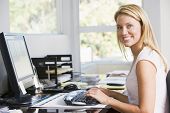 stock photo of home  - Woman sat working in home office - JPG 