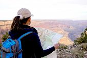 image of map  - Adventurous female at the Grand Canyon holding a map - JPG 
