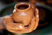 image of pressure  - hand made muddy pot close up view - JPG 