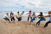 stock photo of teenager  - Teenagers playing tug of war - JPG 