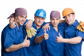 stock photo of construction  - A friendly young team of construction workers shows thumbs sign okay - JPG 