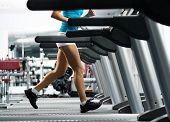 foto of fitness  - woman running on a treadmill in a fitness club - JPG 