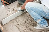 picture of construction worker  - Mason building a screed coat cement in France - JPG 