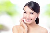 stock photo of beauty  - close up of Beauty woman Face and hand touch her face with green background for skin care concept model is a beautiful asian girl - JPG 