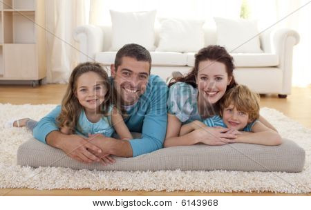 Picture or Photo of Happy family on floor lying in living-room