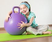 picture of fitness  - smiling  girl with the fitness ball   at home - JPG 