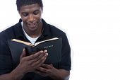 picture of religion  - A young black man reading the Holy Bible on a white background - JPG 