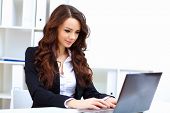 picture of notebook  - Young pretty business woman with notebook in the office - JPG 