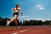pic of competition  - Athletic woman running on track - JPG 