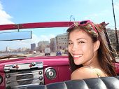 stock photo of seating  - Car woman smiling happy on passenger seat in pink vintage convertible car - JPG 