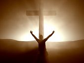 picture of religion  - Silhouette of a man kneeling with arms lifted up at the Cross of Jesus - JPG 