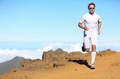 stock photo of fitness  - Runner man trail running in scenic landscape nature in compression clothing - JPG 