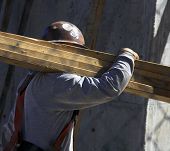 stock photo of construction worker  - on a hot day a construction worker tending to his job - JPG 
