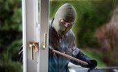 foto of house  - A burglar at a window of a house - JPG 