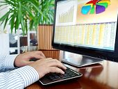 pic of investment  - Male hands on the keyboard in front of computer screen with financial data and charts - JPG 