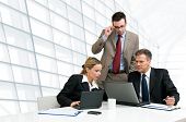 stock photo of meeting  - Group of business people analyzing and discussing during a working meeting in a modern office - JPG 