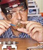 picture of watch  - Watch repair craftsman repairing watch - JPG 