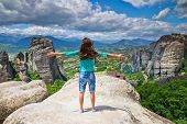 stock photo of valley  - woman on top of a mountain and enjoying valley view - JPG 