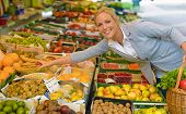 pic of food  - a young woman buying fruits and vegetables at a market - JPG 